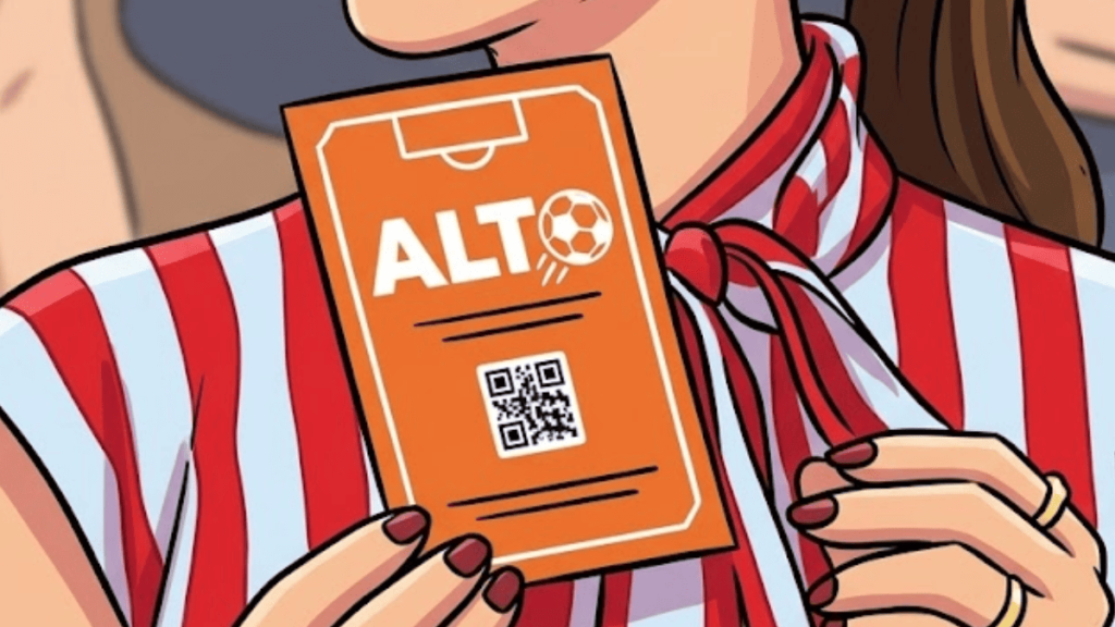 Person Holding an Orange Ticket Labeled  - Regio Politica'ALT' with a small soccer ball icon and a QR code on the front.