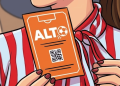 Person Holding an Orange Ticket Labeled 'alt' with a Small Soccer Ball Icon and a Qr Code on the Front. - Regio Politica
