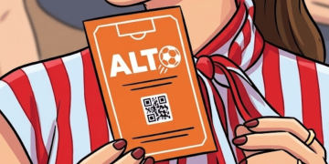 Person Holding an Orange Ticket Labeled 'alt' with a Small Soccer Ball Icon and a Qr Code on the Front. - Regio Politica